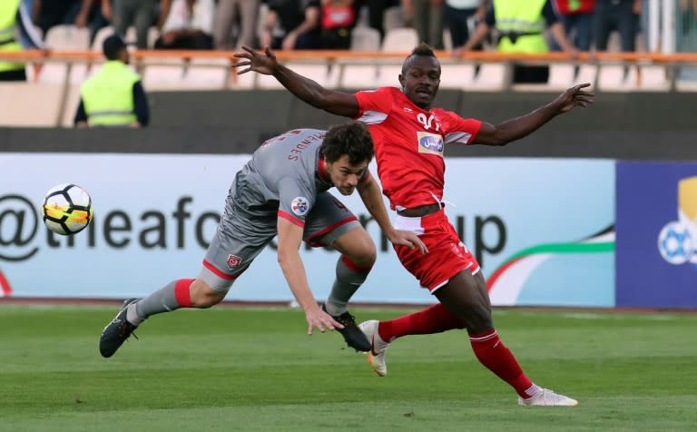 Perspolis' Godwin Mensha (right) in action in Tehran, he is one of the stalwarts of the Iranian giants' campaign