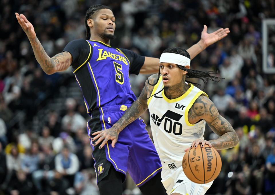 Utah Jazz guard Jordan Clarkson (00) drives around Los Angeles Lakers forward Cam Reddish (5) as Utah and Los Angeles play at the Delta Center in Salt Lake City on Saturday, Jan. 13, 2024.