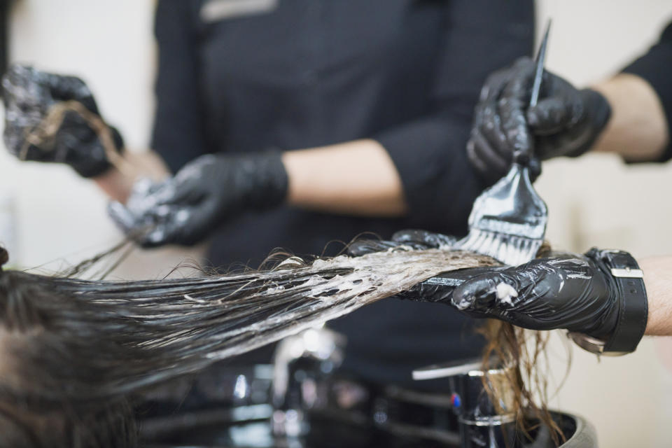 hair stylist applying color