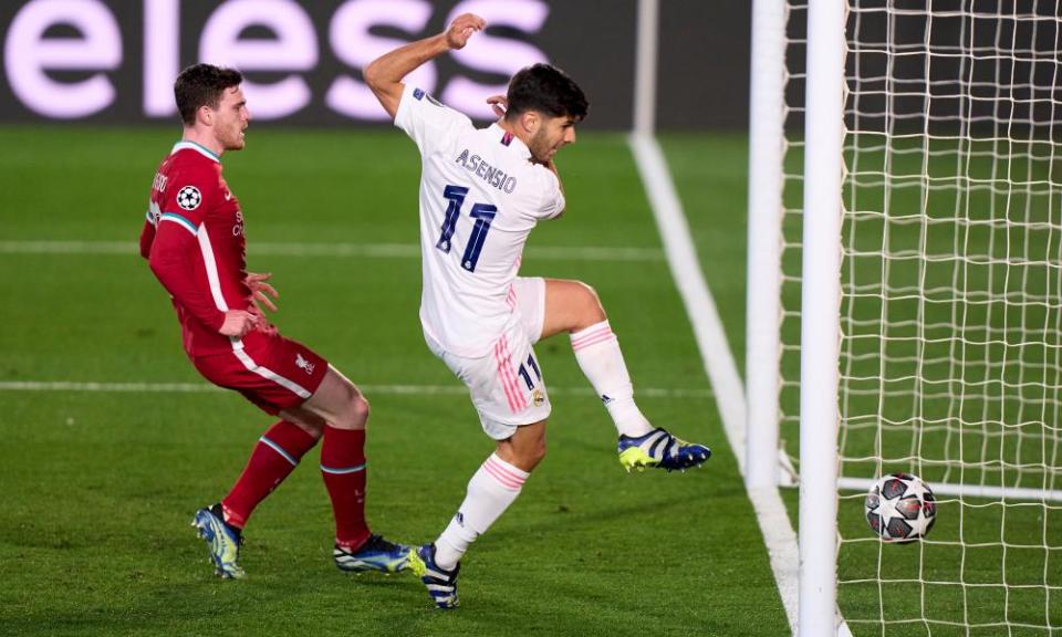 Marco Asensio of Real Madrid scores the second goal against Liverpool after flicking the ball over the Reds goalkeeper Alisson.