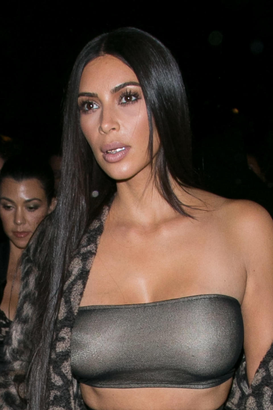 Kim Kardashian West wearing a bandeau top and Dolly Cohen grillz