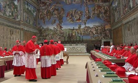 Cardinals enter the Sistine Chapel to begin the conclave in order to elect a successor to Pope Benedict, in a still image taken from video at the Vatican March 12, 2013. REUTERS/Vatican CTV via Reuters Tv