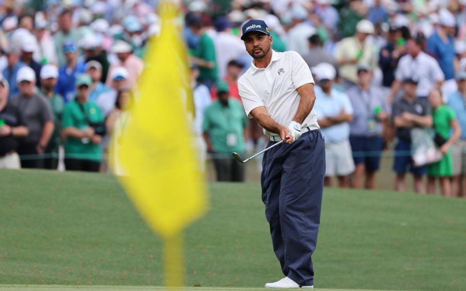 Australia's Jason Day chips onto the green on the 6th hole during the first round