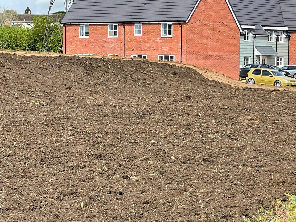 Contractors left the 2.5m mound of topsoil next to new-build Park Place. (SWNS)