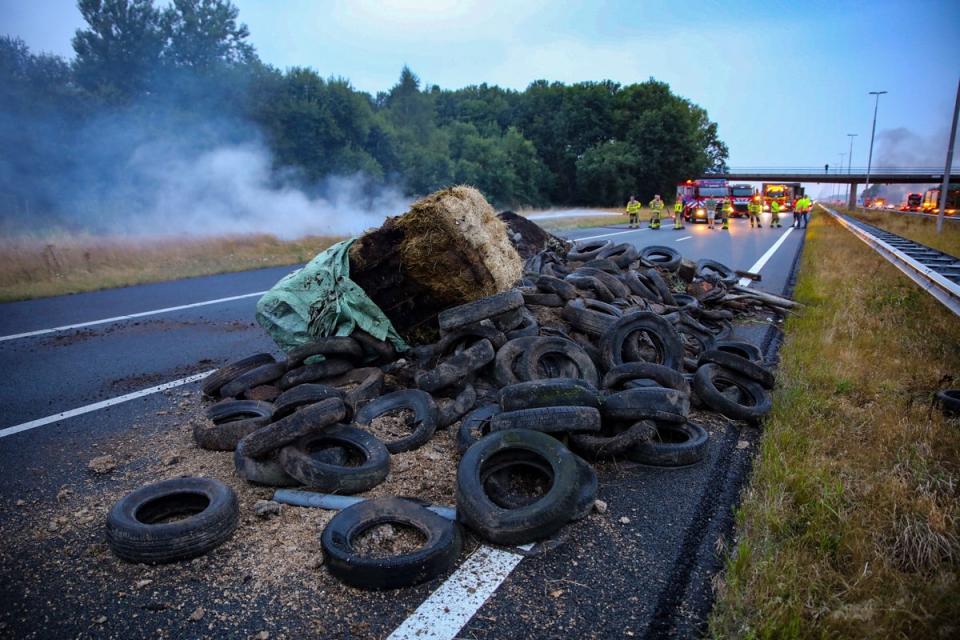 A pile of manure, tires and hay bales on fire (ANP/AFP via Getty Images)