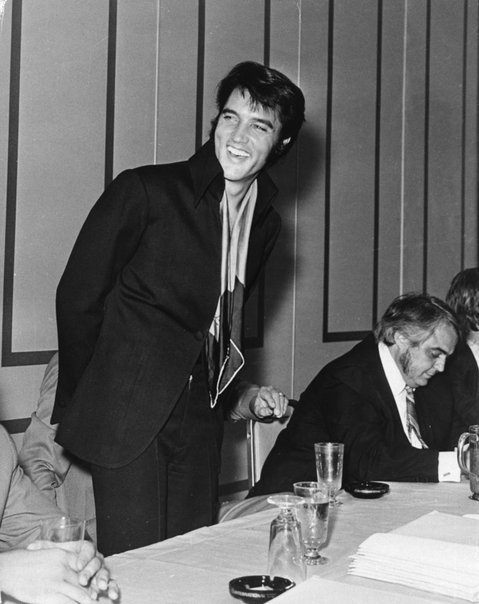 (Original Caption) LAS VEGAS, NEV.: Foreign and domestic newsmen gather around Elvis Presley during an August 1st press conference following his July 31st opening at the International Hotel in Las Vegas, Nevada. "I'm really glad to be back in front of a live audience," Presley told about 150 members of the press. "I don't think I've ever been more excited than I was tonight." Elvis, performing public for the first time in nine years, got four standing ovations during the show.