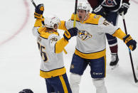 Nashville Predators right wing Michael McCarron, right, congratulates left wing Cole Smith for a goal against the Colorado Avalanche during the first period of an NHL hockey game Saturday, March 30, 2024, in Denver. (AP Photo/David Zalubowski)