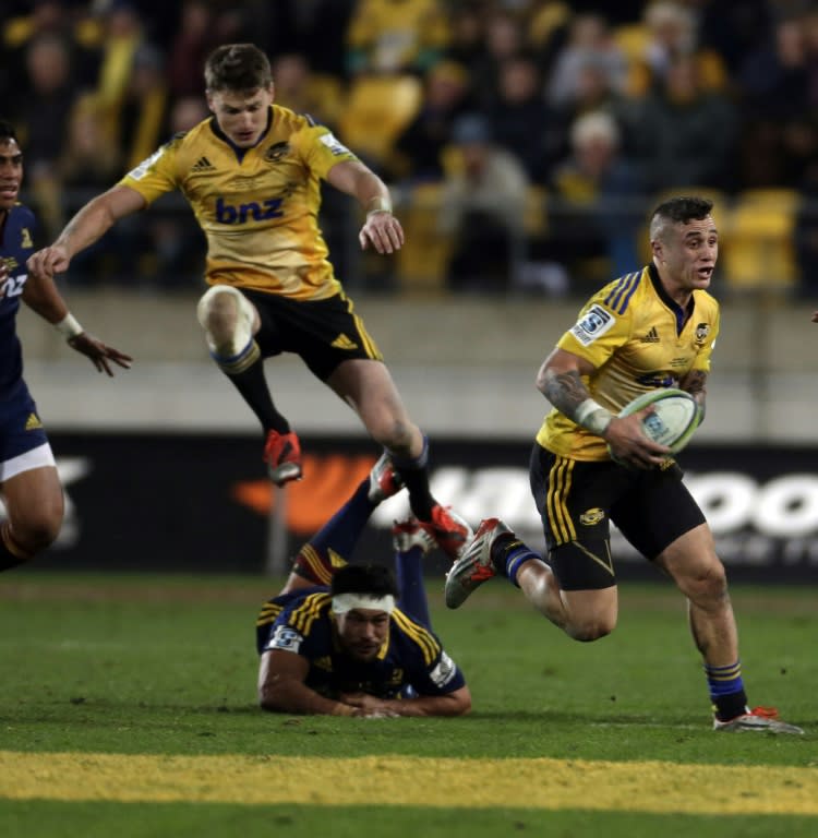 Wellington Hurricanes' TJ Perenara (R) attacks during the Super 15 rugby union final against the Otago Highlanders at Westpac Stadium in Wellington on July 4, 2015