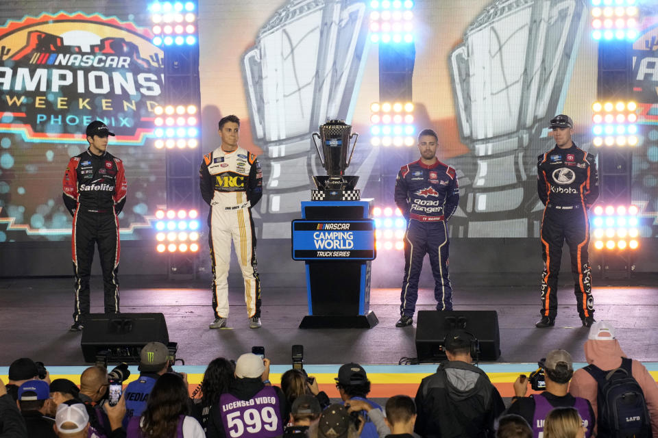 Chandler Smith, Zane Smith, Ty Majeski and Ben Rhodes, from left, pose with the trophy before the NASCAR Truck Series auto race Friday, Nov. 4, 2022, in Avondale, Ariz. (AP Photo/Rick Scuteri)
