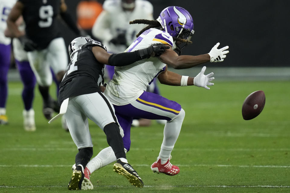 Las Vegas Raiders cornerback Amik Robertson (21) breaks up a pass intended for Minnesota Vikings wide receiver K.J. Osborn during the second half of an NFL football game, Sunday, Dec. 10, 2023, in Las Vegas. (AP Photo/John Locher)