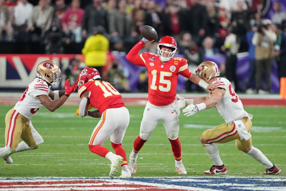Patrick Mahomes passes the ball while under pressure by the 49ers' Nick Bosa during Super Bowl 58.
