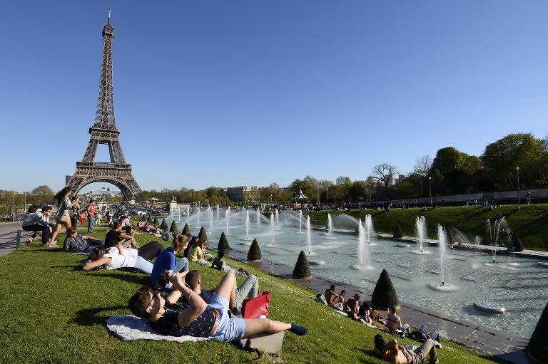 People sunbathe in the Jardins du Trocadero (Trocadero Gardens) near the Eiffel Tower on April 14, 2015 in Paris