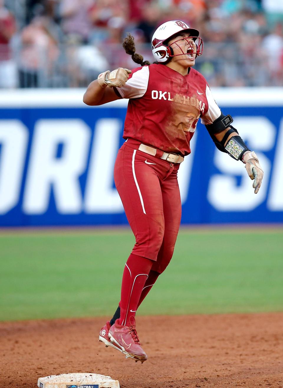 Oklahoma's Alyssa Brito (33) celebrates a double fifth inning during the second game of the championship series in the Women's College World Series between the University of Oklahoma Sooners (OU) and the Texas Longhorns at USA Softball Hall of Fame Stadium in Oklahoma City, Thursday, June 9, 2022. 