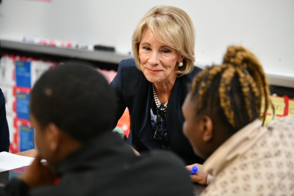 U.S. Secretary of Education Betsy DeVos talks with students at Brockington Elementary School in Timmonsville, S.C., Thursday, Feb. 21, 2019. DeVos made a trip to the state to visit an area once known as the “Corridor of Shame” where officials say dramatic improvements have been made in schools since state officials took over their control last year. (AP Photo/Meg Kinnard)