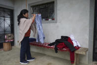 The future first lady of Peru, Lilia Paredes, 48, folds a shirt that belongs to her husband as she packs her family belongings, in the courtyard of her home in Chugur, Peru, Thursday, July 22, 2021. Her husband, leftist Pedro Castillo catapulted from unknown to president-elect with the support of the country's poor and rural citizens, many of whom identify with the struggles the teacher has faced. (AP Photo/Franklin Briceno)