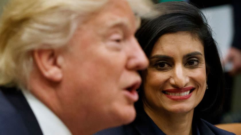 FILE - In this March 22, 2017 file photo, Administrator of the Centers for Medicare and Medicaid Services Seema Verma listen at right as President Donald Trump speaks during a meeting in the Roosevelt Room of the White House in Washington. The Trump administration says it's offering a path for states that want to seek work requirements for Medicaid recipients, and that's a major policy shift toward low-income people. (AP Photo/Evan Vucci, File)