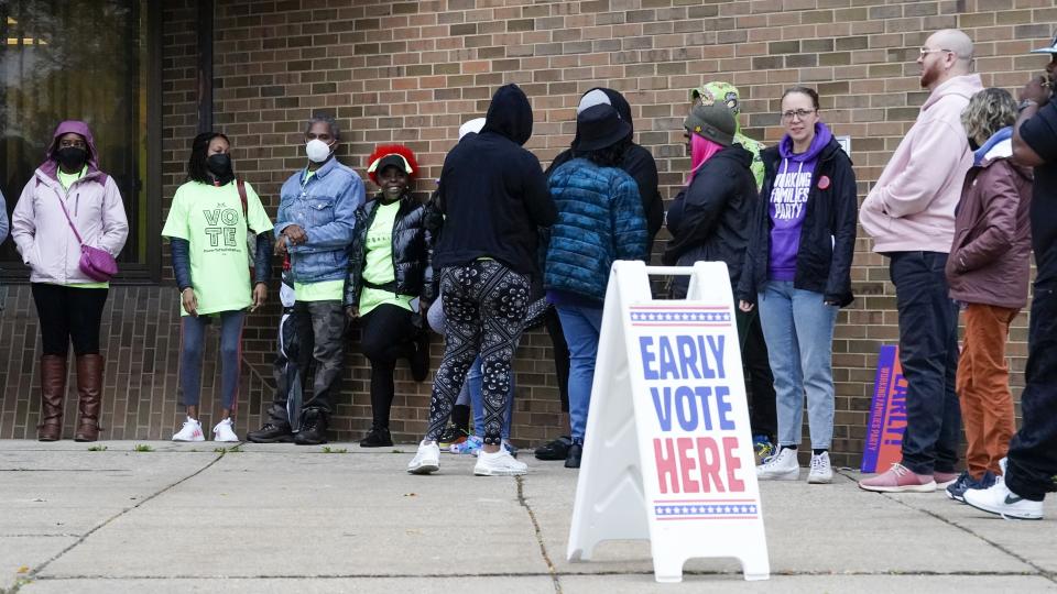 People line up outside a polling station to cast their votes Tuesday, Oct. 25, 2022, in Milwaukee. Tuesday is the first day to vote early in Wisconsin. (AP Photo/Morry Gash)