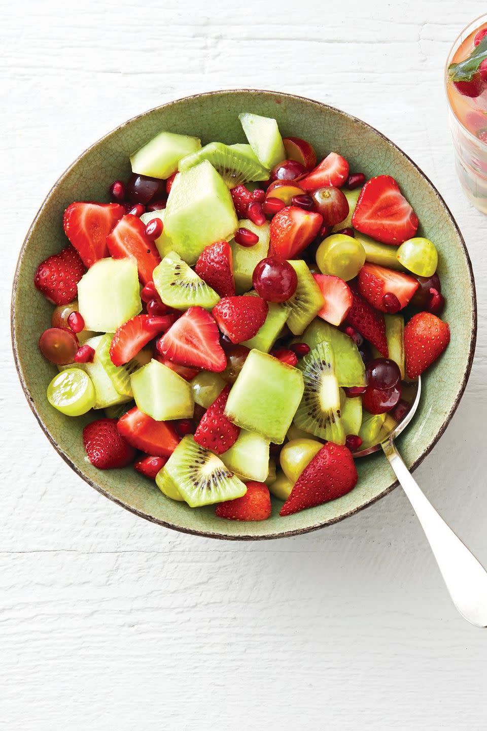 red and green fruit salad with kiwi, strawberries, honeydew, and grapes