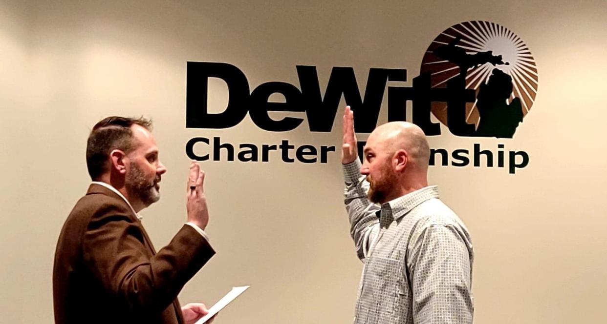 Bob Stump, right, is re-sworn is as a DeWitt Township Police officer Feb. 28, 2022, after being fired several weeks ago. Stump was fired after two years of medical leave after he was seriously injured in an on-duty crash.
