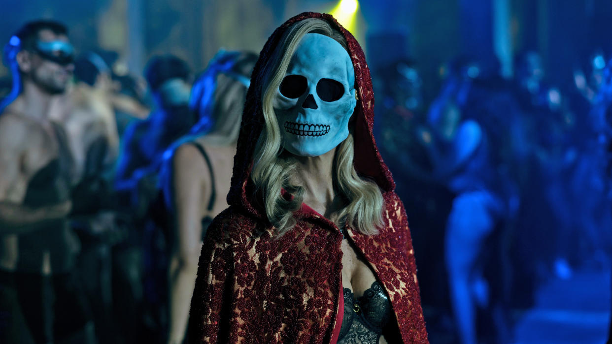  Carla Gugino's Verna stands in a nightclub with a skull mask on in The Fall of the House of Usher 