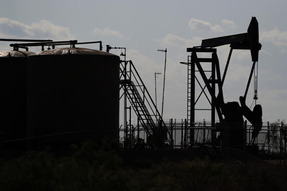 FILE - In this Wednesday, July 29, 2020 file photo, a view of a pump jack operating in an oil field in Midland, Texas. A U.N.-backed study has found that the world needs to cut by more than half its production of coal, oil and gas in the coming decade to maintain a chance of keeping global warming from reaching dangerous levels. The report published Wednesday, Oct. 20, 2021 by the U.N. Environment Program noted that many governments have made ambitious pledges to curb greenhouse gas emissions. But it found they are still planning to extract double the amount of fossil fuels in 2030 than what would be consistent with the goal of keeping global temperature rise below 1.5 degrees Celsius (2.7 degrees Fahrenheit). (AP Photo/Tony Gutierrez, File)