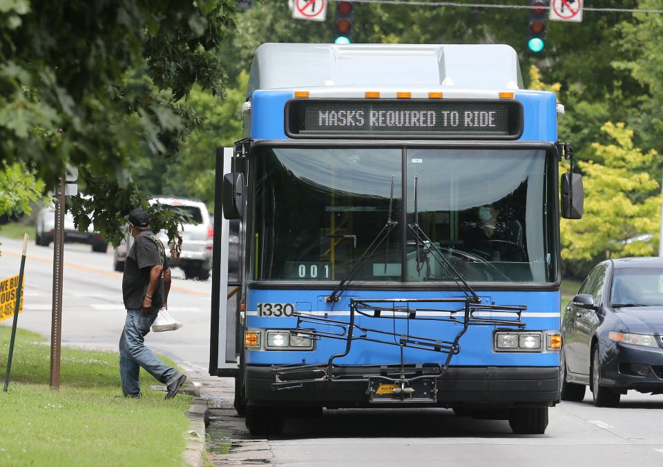 A passenger departs a TARC bus on Eastern Parkway near Preston on Friday, July 17, 2020.