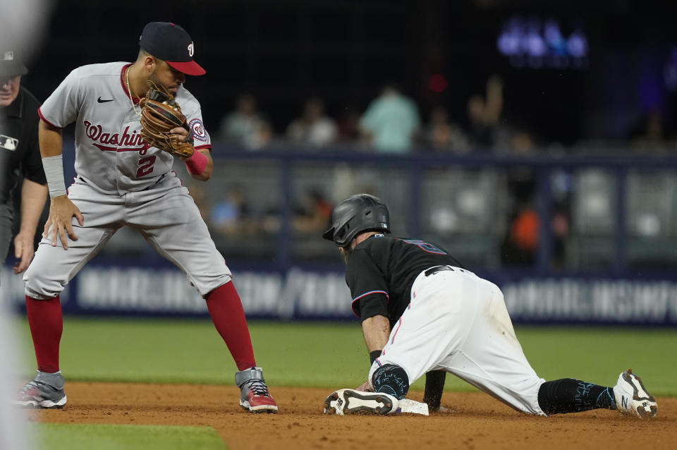 Miami Marlins' Jon Berti (5) steals second base as Washington Nationals shortstop Luis Garcia (2) is late with the tag during the third inning of a baseball game, Friday, Sept. 23, 2022, in Miami. (AP Photo/Marta Lavandier)
