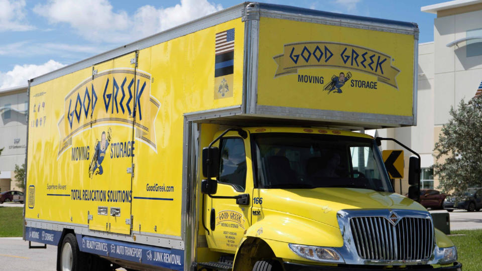 A Good Greek Moving & Storage truck outside one of the company's buildings on a sunny day