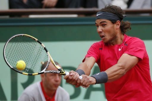 Spain's Rafael Nadal hits a return to Serbia's Novak Djokovic during the French Open men's singles final at Roland Garros in Paris on June 10. Nadal took the first two sets 6-4, 6-3 before Djokovic fought back to win the third 6-2 on a rain-affedted day