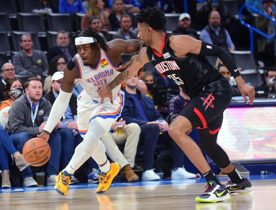 Thunder forward Luguentz Dort, left, pushes past Rockets forward Christian Wood during the second half of a 101-89 win Wednesday at Paycom Center.