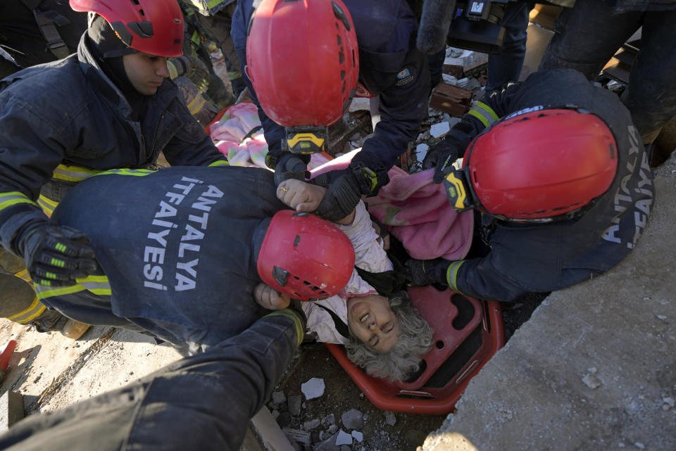 Rescue teams evacuate a survivor from the rubble of a destroyed building in Kahramanmaras, southern Turkey, Tuesday, Feb. 7, 2023. A powerful earthquake hit southeast Turkey and Syria early Monday, toppling hundreds of buildings and killing and injuring thousands of people. (AP Photo/Khalil Hamra)