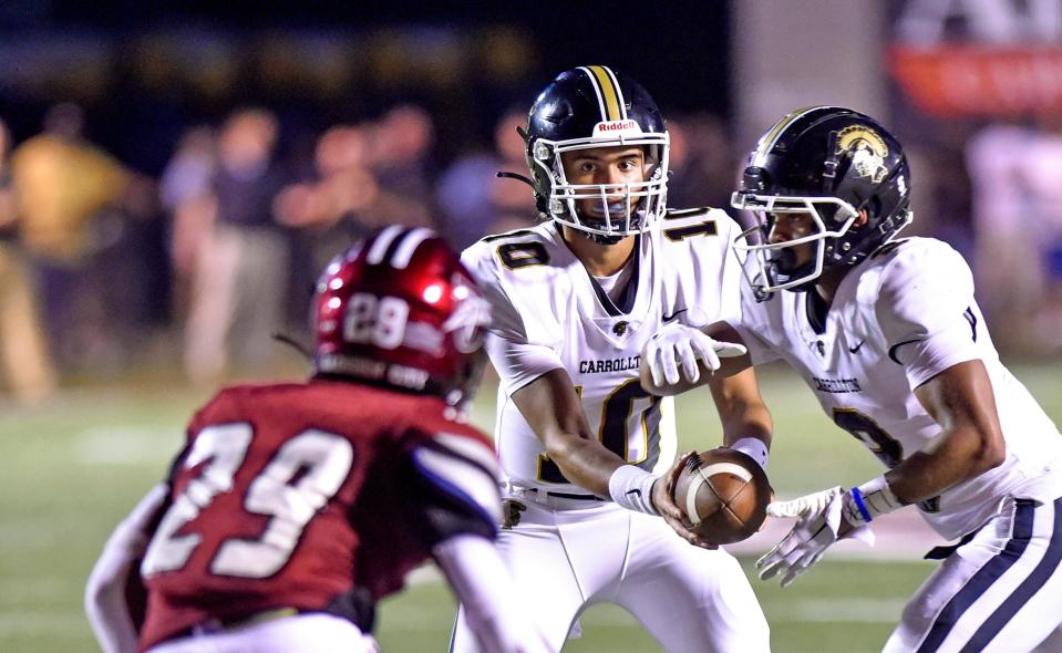 Carrollton quarterback Julian Lewis hands off the football  during high school football action against Gadsden City in Gadsden, Alabama August 19, 2022. (Dave Hyatt: The Gadsden Times)