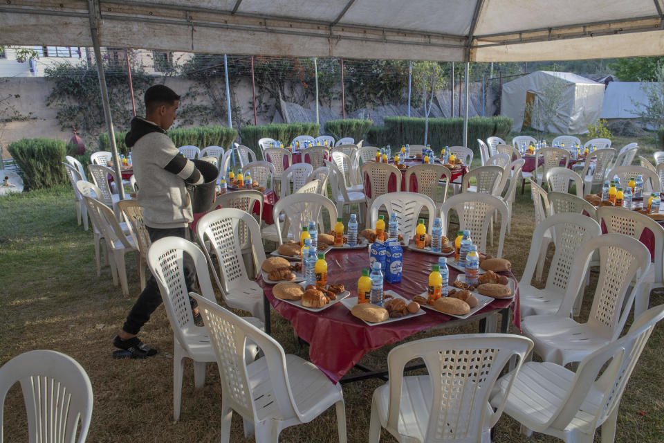 People who have been displaced by the earthquake prepare to host a group Iftar to break their Ramadan fast, in Amizmiz, near Marrakech, Thursday, April 4, 2024. (AP Photo)