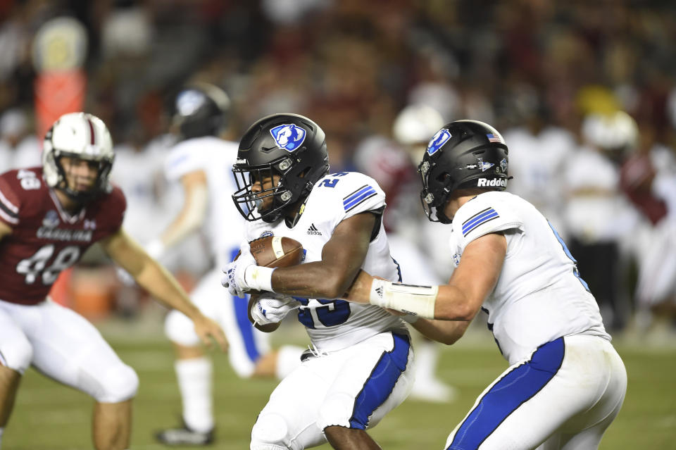 Eastern Illinois running back Kendi Young (29) receives handoff from quarterback Chris Katrenick (9) during the second half of an NCAA college football game against against South Carolina, Saturday, Sept.4, 2021, in Columbia, S.C. (AP Photo/Hakim Wright Sr.)