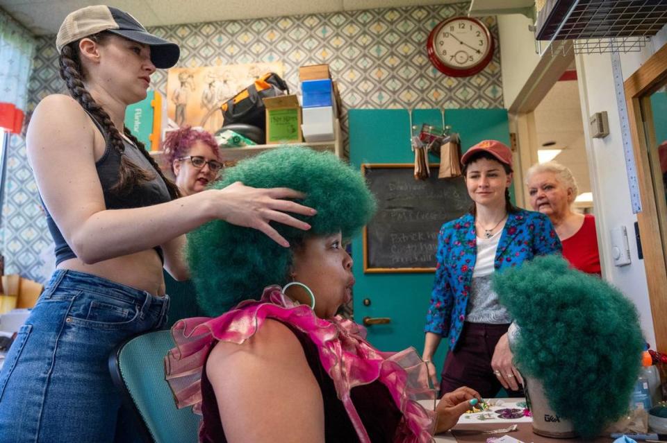 In the fitting room back stage, Mary Williams, left, adjusts the wig on Shon Ruffin, who is cast as Audrey II, in the Kansas City Repertory Theatre’s production of “Little Shop of Horrors.” The fitting on April 17, included Jana Jessee, a fitter/draper, second from left, costume designer Scully Ratke and Gayla Voss, hair and wig co-designer.