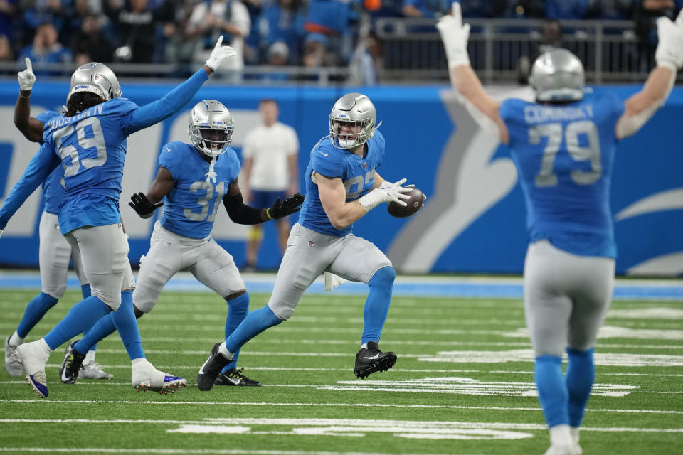 Teammates react after Detroit Lions defensive end Aidan Hutchinson intercepted a pass during the first half of an NFL football game against the Chicago Bears, Sunday, Jan. 1, 2023, in Detroit. (AP Photo/Paul Sancya)