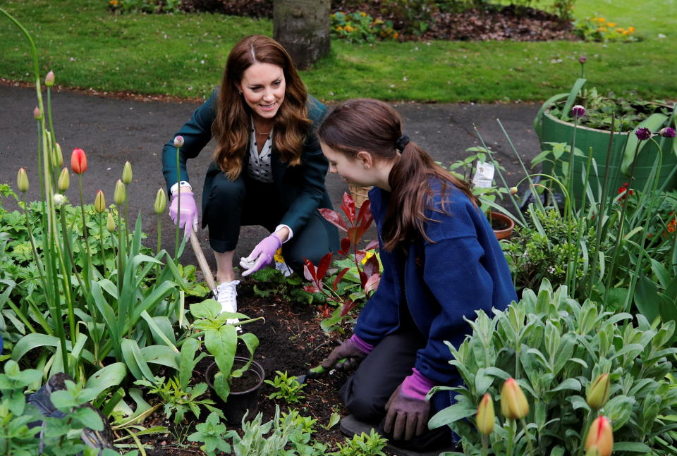 EDINBURGH, SCOTLAND - MAY 27: Catherine, Duchess of Cambridge plants sunflower seeds with a volunteer during their visit to Starbank Park on May 26, 2021 in Edinburgh, Scotland. (Photo by Phil Noble - WPA Pool/Getty Images)