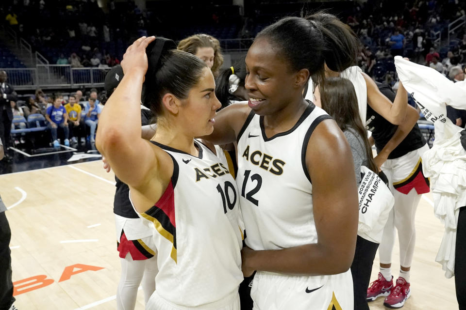 Las Vegas Aces' Chelsea Gray (12) and Kelsey Plum hug after their team beat the Chicago Sky 93-83, to win the WNBA Commissioner's Cup basketball game Tuesday, July 26, 2022, in Chicago. (AP Photo/Charles Rex Arbogast)