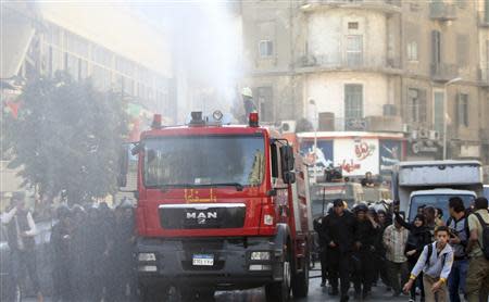 Riot police fire a water cannon to disperse people protesting against a new law restricting demonstrations, in downtown Cairo November 26, 2013. REUTERS/Amr Abdallah Dalsh