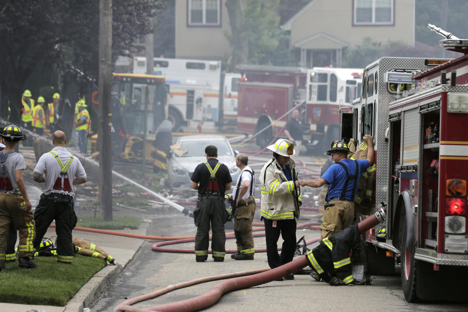 Firefighters and other emergency personnel work at the site of house explosion in Ridgefield, N.J., Monday, June 17, 2019. A home in northern New Jersey has been leveled by an explosion, but the lone person inside the residence apparently escaped serious injury. (AP Photo/Seth Wenig)