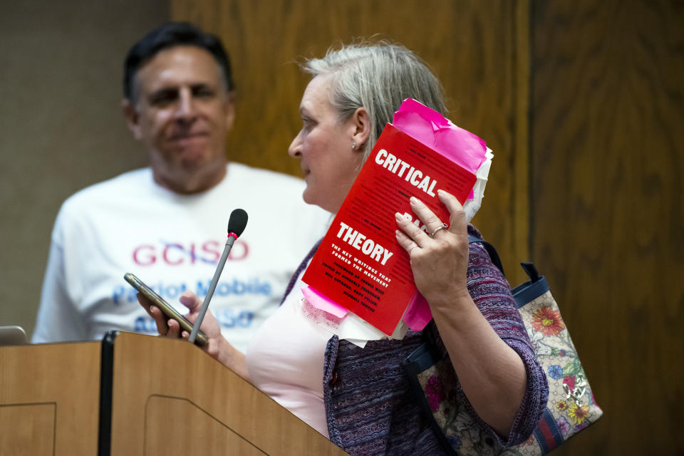 Image: Myra Brown holds up a book about Critical Race Theory as she speaks during the “Public Comment” portion of a Grapevine-Colleyville Independent School District school board meeting in Grapevine, Texas, on Aug. 22, 2022. (Emil T. Lippe for NBC News)