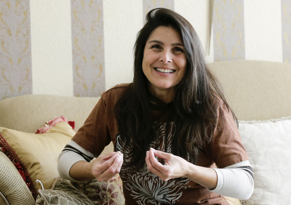 Judith Negron is interviewed at her home in Hialeah, Fla., Wednesday, Feb. 19, 2020. Negron was serving 35 years at a Florida prison for health care fraud, conspiracy and money laundering when she was released Tuesday after President Donald Trump commuted her sentence. (AP Photo/Terry Renna)