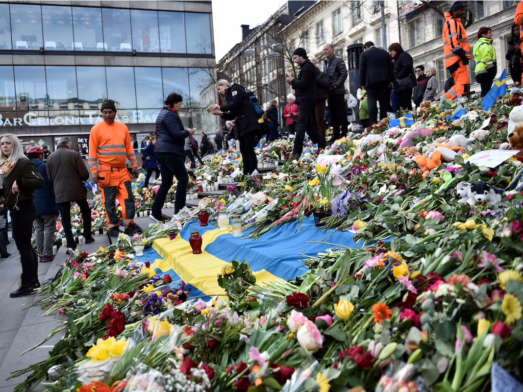People leaving flowers on the steps on Sergels Torg following Friday's terror attack in central Stockholm, Sweden, Sunday, April 9, 2017.