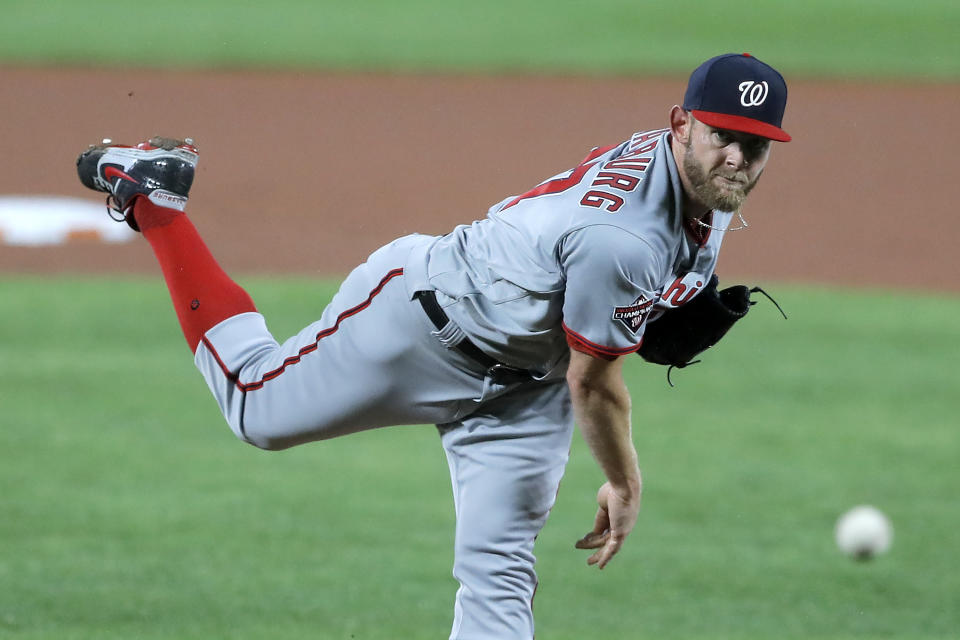 Washington Nationals starting pitcher Stephen Strasburg throws a pitch to the Baltimore Orioles during the first inning of a baseball game, Friday, Aug. 14, 2020, in Baltimore. (AP Photo/Julio Cortez)