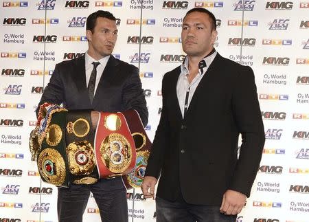 Ukrainian WBA, WBO, IBO and IBF heavyweight boxing world champion Vladimir Klitschko (L) and his challenger Bulgarian Kubrat Pulev pose for the media in Hamburg June 25, 2014. Klitschko will face Pulev on September 6 in Hamburg. REUTERS/Fabian Bimmer