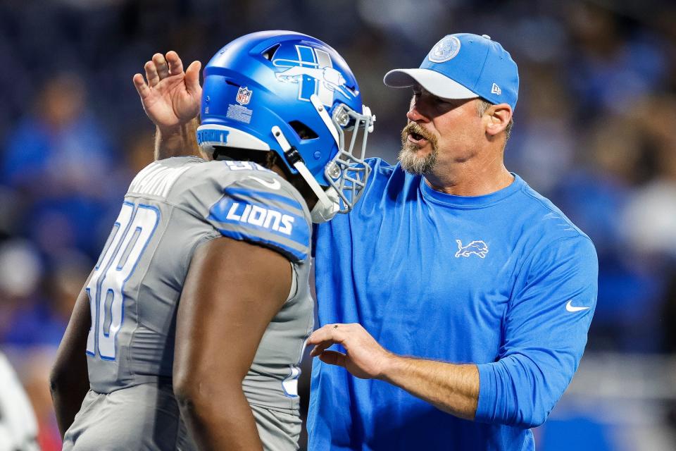 Lions coach Dan Campbell talks to defensive tackle Brodric Martin during warmups before the game against the Raiders on Monday, Oct. 30, 2023, at Ford Field.