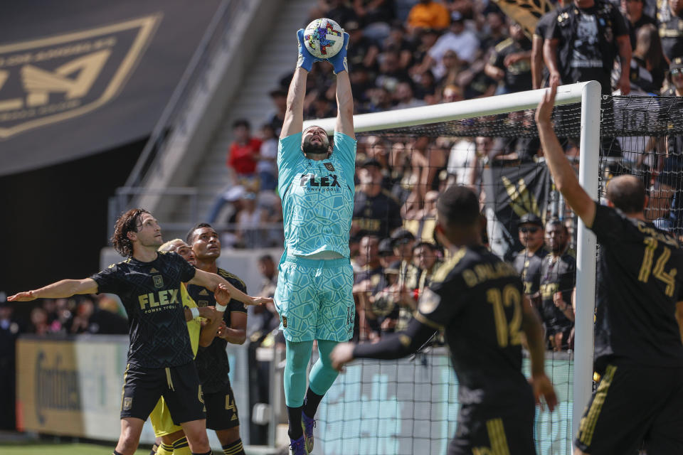 Los Angeles FC goalkeeper Maxime Crepeau, center, makes a catch against the Nashville SC during the first half of an MLS soccer match Sunday, Oct. 9, 2022, in Los Angeles. (AP Photo/Ringo H.W. Chiu)