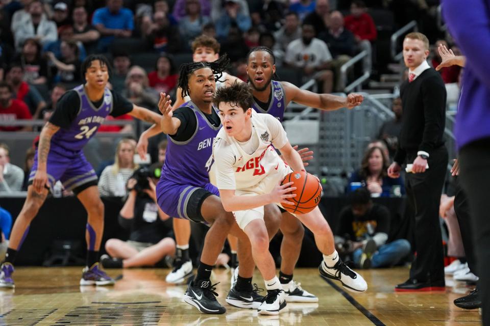 Fishers Tigers Cooper Zachary (4) looks for an open man against the Ben Davis Giants on Saturday, March 30, 2024, during the IHSAA boys basketball Class 4A state championship game at Gainbridge Fieldhouse in Indianapolis. The Fishers Tigers defeated the Ben Davis Giants 65-56.