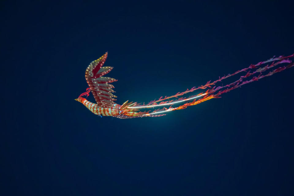 Tourists watched a remote-controlled performance of a flying phoenix during an early Lantern Festival celebration in Chongqing, China, on Feb. 23, 2024. <span class="copyright">Future Publishing—Getty Images</span>