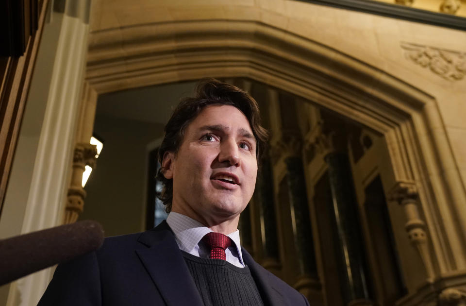 Canadian Prime Minister Justin Trudeau speaks with the media as he makes his way to caucus, Wednesday, Dec. 8, 2021, in Ottawa, Ontario. (Adrian Wyld/The Canadian Press via AP)